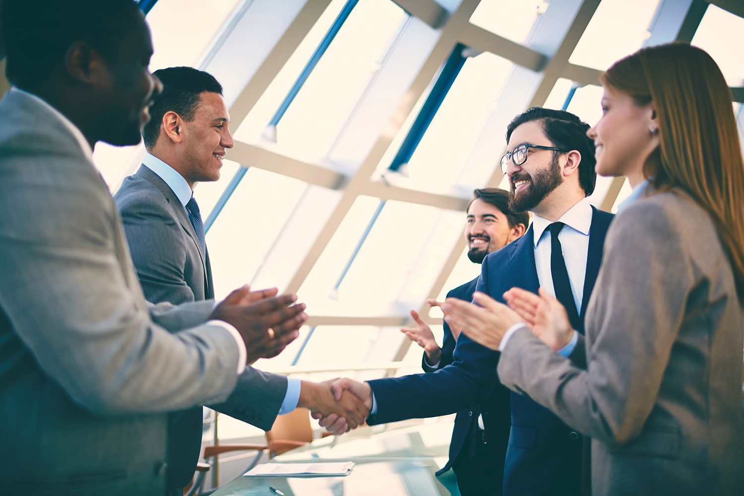 Business partners greeting each other after signing contract